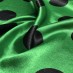 Атлас стрейч, черные горохи 45 мм на зеленом